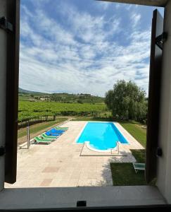 a view of a swimming pool from a window at Agriturismo Fioravante in San Pietro in Cariano