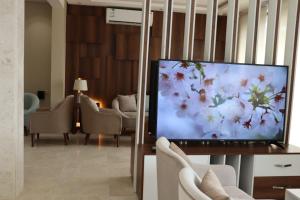 a living room with a large flat screen tv at أبهى سكن للشقق المخدومة in Abha