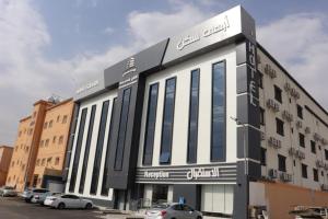 un edificio con coches estacionados en un estacionamiento en أبهى سكن للشقق المخدومة, en Abha