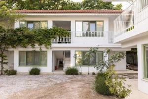 a white house with a lot of windows at Casa De Mare in Olimp