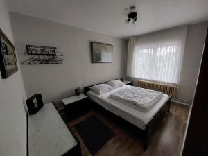 a small bedroom with a bed and a window at Repos St Elisabeth nabij Plopsaland in De Panne