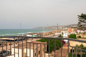 a view of a beach with the ocean and buildings at Bella Address Hotel Beach in Saïdia