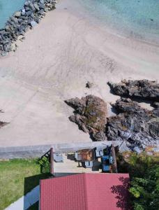an aerial view of a beach and the ocean at Cosy Portmor Log Cabin in Malin Head