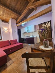 a living room with a red couch and a table at La Casa dei Tigli in Cannara