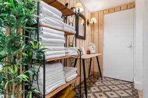 a room with a rack of towels at Hôtel & Espace Bien-être La Maison du Lierre in Biarritz +37 photos