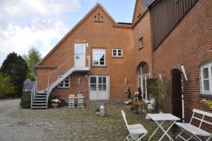 a brick building with a staircase on the side of it at Lundsgaard Apartments in Fåborg