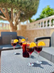 a row of wine glasses sitting on a table at Olive Tree Bungalow La Zenia in Orihuela Costa