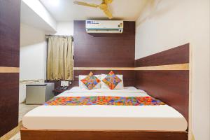 1 dormitorio con 1 cama grande en una habitación en FabHotel Shravan, en Nagpur
