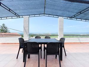 a black table and chairs on a patio at Villa Paz in Villanueva de Castellón