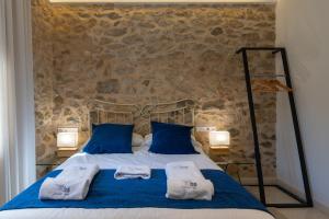 a bedroom with a bed with two towels on it at LA CASA DEL PANTANO in La Vall de Laguar +82 photos