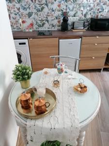 a white table with pancakes on it in a kitchen at APARTAMENTO ABADIA in Málaga