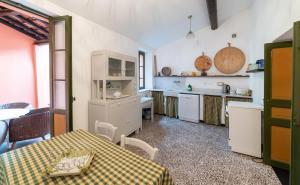 a kitchen with a table and a table and a table and a kitchen at Agriturismo Castel Dho in Castel Vittorio