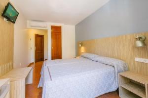 Łóżko lub łóżka w pokoju w obiekcie Hotel Galicia