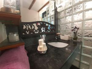 a bathroom with a sink and a candle on a counter at Maresme´s corner in Sant Andreu de Llavaneres