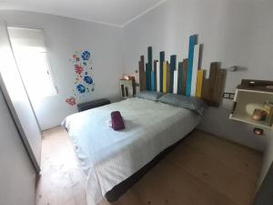 een slaapkamer met een groot bed met boeken aan de muur bij Maresme´s corner in Sant Andreu de Llavaneres