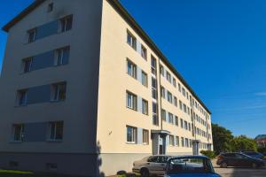 a building with a car parked in front of it at Kuuse 4 Apartment in Haapsalu