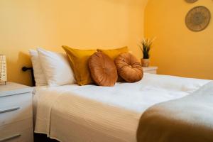 a bedroom with a bed with pillows on it at Market Square - street Rynek 24 -2 Rooms in Wrocław