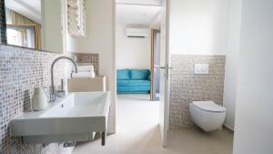 La salle de bains est pourvue d'un lavabo et de toilettes. dans l'établissement Maravida Vacation Rooms, à Dobrovo