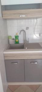 a kitchen with a sink and a counter top at Apartment Tuja in Jadrtovac