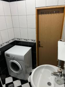 a washing machine in a bathroom next to a sink at Apartment Kotor Old Town in Kotor