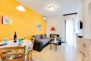 a living room with a couch and a table at Apartman Kovač in Malinska