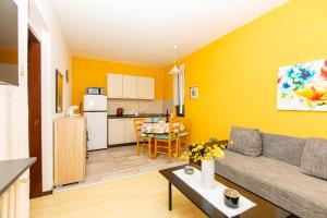 a living room with a couch and a table at Apartman Kovač in Malinska