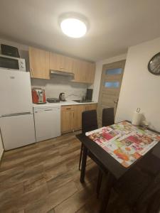 a small kitchen with a table and a refrigerator at Premium Terrace Apartament in Krakow