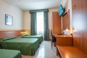 Postel nebo postele na pokoji v ubytování Hotel Stadio & Spa