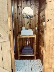 a small bathroom with a sink and a sink at Tente Glamping nature et océan, Rogil in Rogil