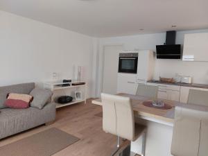 a kitchen and living room with a table and a couch at Klosterblick in Bad Doberan