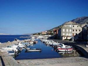 a group of boats are docked in a harbor at Holiday House Rose in Karlobag