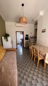 een woonkamer met een tafel en stoelen en een koelkast bij Drè Marèna in Rimini