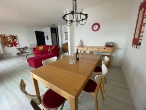a dining room and living room with a wooden table and chairs at Gioia in Oggebbio