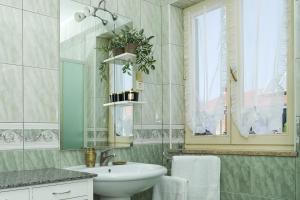 a bathroom with a sink and a mirror at Villa Mareonda - Apartments Sussurro in Rovinj