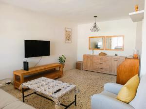a living room with a tv and a couch at Villa Service - Torre Barot 5º in Calafell
