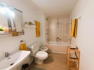 a bathroom with a white toilet and a sink at Villa Service - Torre Barot 5º in Calafell +16 photos