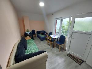 a living room with a couch and chairs and a window at Dušanov Zaliv - Perućac in Skelani