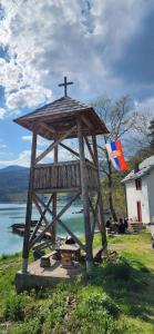 a wooden structure with a cross on top of it at Dušanov Zaliv - Perućac in Skelani