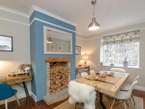 a dining room with a table and a fireplace at CASTLE COTTAGE 2 in Richmond