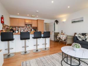 a kitchen and living room with a couch and a table at Far Horizons in Newquay