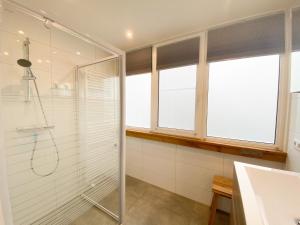 a bathroom with a shower and a glass shower stall at Vakantiehuis Oostkapelle OK20 in Oostkapelle +25 photos