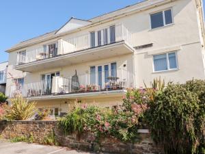 an apartment building with balconies and flowers at Far Horizons in Newquay