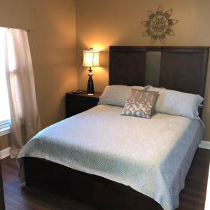 a bedroom with a large bed with a lamp on it at Indies 110 in Gulf Shores
