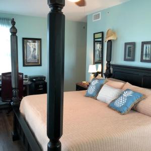 a bedroom with two beds with blue walls at Indies 110 in Gulf Shores