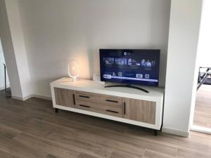 a flat screen tv sitting on top of a cabinet at lacaletasol in Villajoyosa