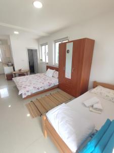 - une chambre avec 2 lits jumeaux et une armoire dans l'établissement Apartments Three Ohrid, à Ohrid