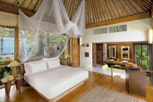 a bedroom with a white bed and a desk at Six Senses Samui in Choeng Mon Beach