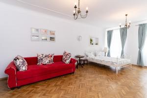 a living room with a red couch and a table at Downtown Sibiu in Sibiu