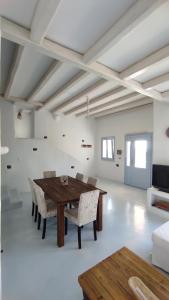 a dining room with a wooden table and chairs at The Sundown Villa in Parasporos