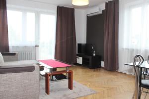 a living room with a couch and a table at Travel Apartament Cracow in Kraków